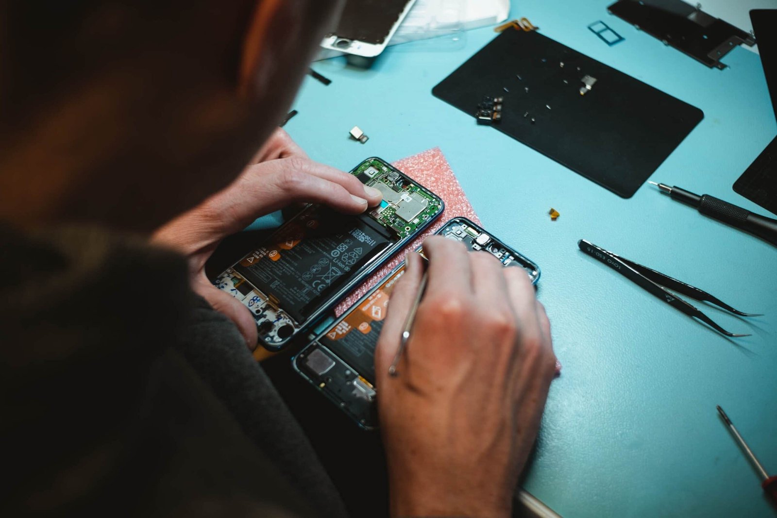 person repairing a cell phone